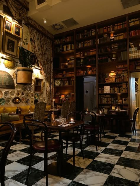 Goth Cafe Interior, Library Bakery Aesthetic, Old Fashioned Cafe Interior, Cozy Coffee Shop Aesthetic Vintage, Coffee Shop Dark Academia, Coffee Shop Interior Design Cozy Vintage, Gothic Cafe Interior, Cozy Bookshop Cafe Aesthetic, Bookstore Cafe Aesthetic Vintage