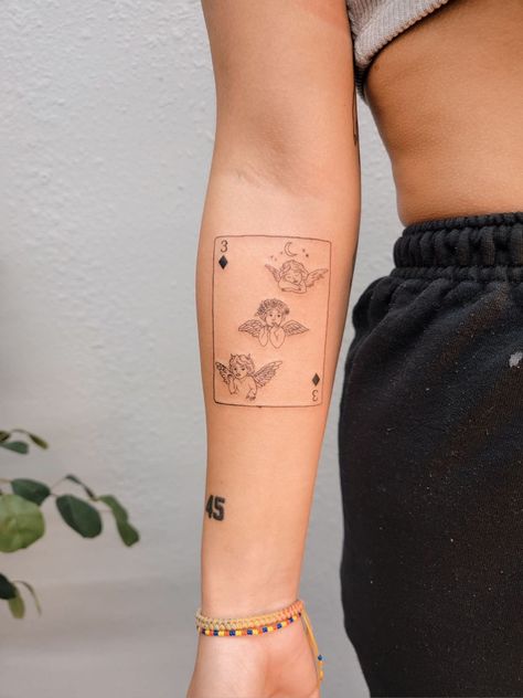 Fine line tattoo of 3 of diamonds playing card with cherubs or baby angels as symbols Angel Card Tattoo, Playing Cards Tattoo, Playing Card Tattoo, Playing Card Tattoos, Cherub Tattoo, Tarot Card Tattoo, Angel Tarot Cards, Angel Card, Angel Tarot