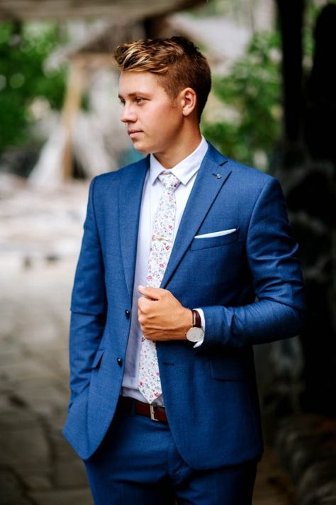 A blue suit and a floral-printed tie is the perf spring groom look! | Image by Karina and Maks Navy Blue Groomsmen Suits Floral Tie, Navy Blue Groom Suit Floral Tie, Blue Suit Floral Tie Wedding, Navy Blue Suit With Floral Tie, Ties For Blue Suits, Navy Suit With Floral Tie, Floral Tie Navy Suit, Blue Suit With Floral Tie, Navy Suit Floral Tie Wedding