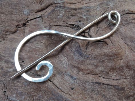 "This pin is so beautiful in its simplicity! One swirl of hammered metal that won't cover the beauty of your shawl or scarf.  You can get it in German silver (photo 1-4), sterling silver (photo 5 - bare, 6 - antique), copper (photo 7 - bare, photo 8, 9 - antique) or brass (photo 10).  Copper and sterling silver can be oxidized for warm antique look.  It is very sturdy pin with great capacity. Pin measures about 2.5\" or 6 cm long. Hand made out of sturdy German silver this safety pin has a medium size and is suitable for all knitted and loose fiber fabrics.  Pin measures around 2.5 inches / 6 cm long.  The metal is hammered to add to its beauty and strength.  The needle tip is slightly sharpened to slide effortlessly through knit yarns. The pin will hold securely your kilt, shawl or scarf. Modern Shawl, Silver Shawl, Sweater Brooch, Silver Engraved Bracelet, Silver Scarf, Hammered Silver Jewelry, Silver Jewelry Diy, German Silver Jewelry, Silver Rings With Stones