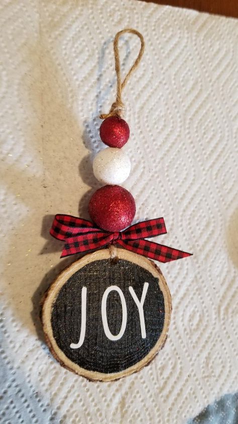 Handmade "Joy" rustic farmhouse ornament.  Great for trees or decorative trays.  Made to order so each may vary slightly. Wood Slice Ornaments With Fabric, Rustic Wood Christmas Ornaments, Diy Farmhouse Tree Ornaments, Joy Christmas Craft, Bell Crafts Christmas, Homemade Farmhouse Christmas Ornaments, Wooden Slice Ornaments Diy, Ideas For Round Wood Pieces, Simple Christmas Tree Ornaments