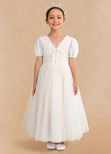 Have your flower girl match the bride in our lace and tulle flower girl dress Cressidia. She features a flattering pleated V-neckline, full length bishop sleeves, and a corset style lace-up back. Your guests will ooh and aah at how elegant she is. Classic Flower Girl Dress, Pleated Tulle Dress, Elegant Flower Girl Dress, Champagne Flower Girl, Vintage Flower Girls, Flower Girl Dresses Champagne, White Champagne, Girl Sleeves, Tulle Flower Girl