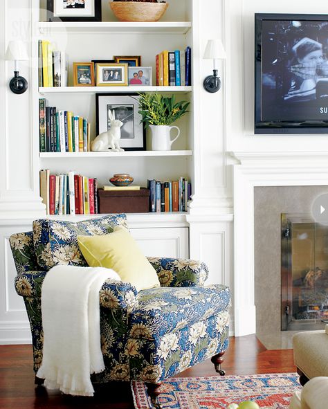 Stylish shelving Oil-rubbed bronze wall sconces flank the built-in bookcase for symmetry and are characteristic of the home’s period, as is the William Birch-style chair with turned feet. The intricate moulding, Maureen’s specialty, on the built-in is carried throughout the home. Book Cases By Fireplace, Bookshelves Flanking Fireplace, Fireplace Moulding, Bookshelves Room, Bookcase Decorating, Bookshelf Tv, Styling Bookshelves, Fireplace Bookshelves, Tv Area