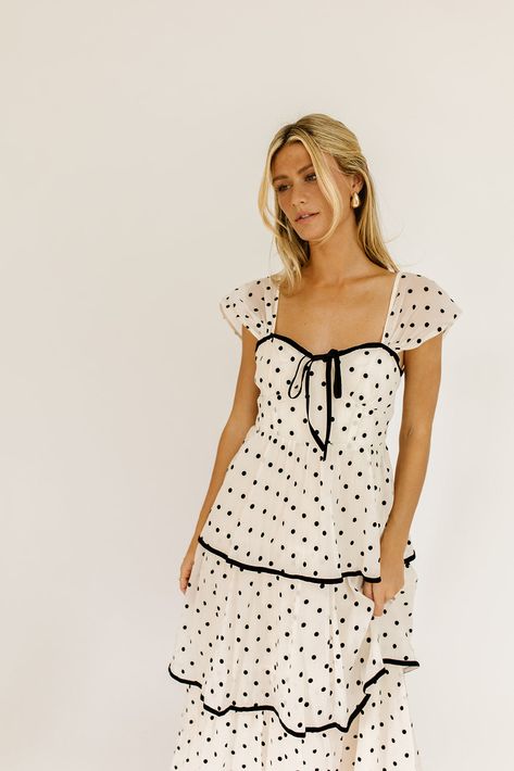 the retro-inspired dress of our dreams. it features sheer short sleeves, a ribbon tie bodice, + dainty ruffle details. both sweet + sophisticated, this off-white + black polka dot midi dress is perfect for fancy dinner dates, holiday parties, + anytime you’re feelin’ frilly. off white + black polka dots // midi length, sweetheart neckline, sheer polka dot sleeves, back zipper closure, tiered skirt, lined model is 5'8" + wearing a small measurements are approximate + taken while laying flat xsmal Polka Dot Bridesmaid Dresses, Cute Dresses Photoshoot, Polka Dot Cocktail Dress, Polka Dot Bridesmaid Dress, Church Dresses Fall, Fun Midi Dress, Polka Dot Dress Black And White, Outfit Ideas With Dresses, Winter Dresses Short