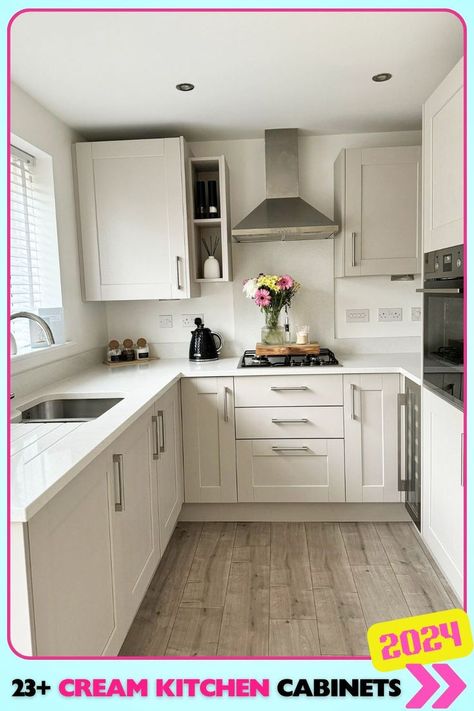 Compact corner kitchen with cream cabinets and a bright window view maximizes space while maintaining an open, inviting feel. Perfect for small kitchens looking for cream kitchen cabinet ideas that provide both style and functionality. Cream And Gold Kitchen, Kitchen With Cream Cabinets, Cream Kitchen Cabinet, Cream Kitchen Ideas, Cream Gloss Kitchen, Cream And White Kitchen, Neutral Kitchen Cabinets, Off White Kitchen Cabinets, Shaker Style Kitchen Cabinets