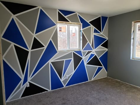 Geometric accent wall with light grey, dark grey, black and blue. The other walls are the dark grey. Geometric Wall Paint Patterns Blue, Blue And Grey Bedroom Walls, Black And Blue Wall Painting Ideas, Blue Triangle Wall Paint, Wall Painting Ideas Bedroom Boys, Geometric Wall Paint Blue, Black And Blue Bedroom Ideas, Wall Painting Ideas Geometric, Wall Paint Designs Bedroom