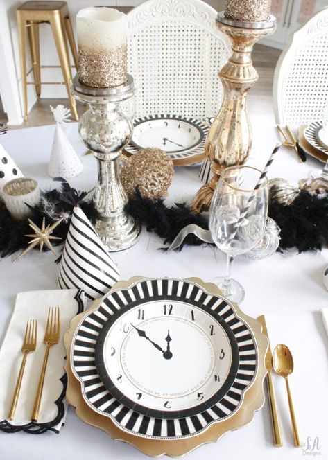 black white gold tablescape, black and white striped graces dinner plates, gold chargers, crystal chandelier, clock plates new years eve, new years eve game, new years eve food, mercury glass candlesticks, sugar paper la white black scalloped dinner napkins, party hat, mercury glass candlesticks, glitter candles New Year’s Eve Place Setting, New Years Place Setting, New Years Table Centerpieces, New Years Brunch Decorations, New Years Dinner Party Table Settings, New Year’s Eve Tablescape, New Year’s Eve Table Setting, New Years Centerpiece Ideas, New Years Table Decor