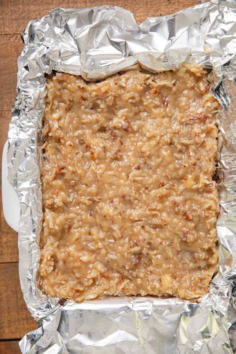 German Chocolate Fudge in baking dish lined with foil German Chocolate Fudge, German Chocolate Fudge Recipe, German Chocolate Fudge 12 Tomatoes, Chocolate Fudge With Nuts Recipes, Penuche Fudge 12 Tomatoes, Hershey's Old Fashioned Rich Cocoa Fudge, Linda’s Fudge Cake, Holiday Candy Recipes, Coconut Pecan Frosting