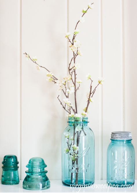 Vintage Blue Ball Jars and Insulators used on a Spring Mantel - #springmantel #springdecor #vintage #vintagedecor #balljars Blue Ball Jars Decorating With, Blue Ball Jars, Pretty Farmhouse, Diamond House, Antique Baskets, Spring Mantel, Herringbone Wall, Jar Display, Scrabble Wall Art