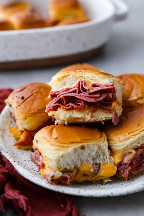 These copycat Arby's beef and cheddar sliders are a must-make for your next gathering. Soft Hawaiian buns topped with sliced roast beef, melty American cheese, onion flakes, and homemade Arby's sauce, brushed with a buttery glaze. Beef And Cheddar Sliders, Arbys Beef And Cheddar, Arby's Sauce, Baked Stuffed Pork Chops, Dinner Potluck, Roast Beef And Cheddar, Beef And Cheddar, Hawaiian Buns, Onion Flakes