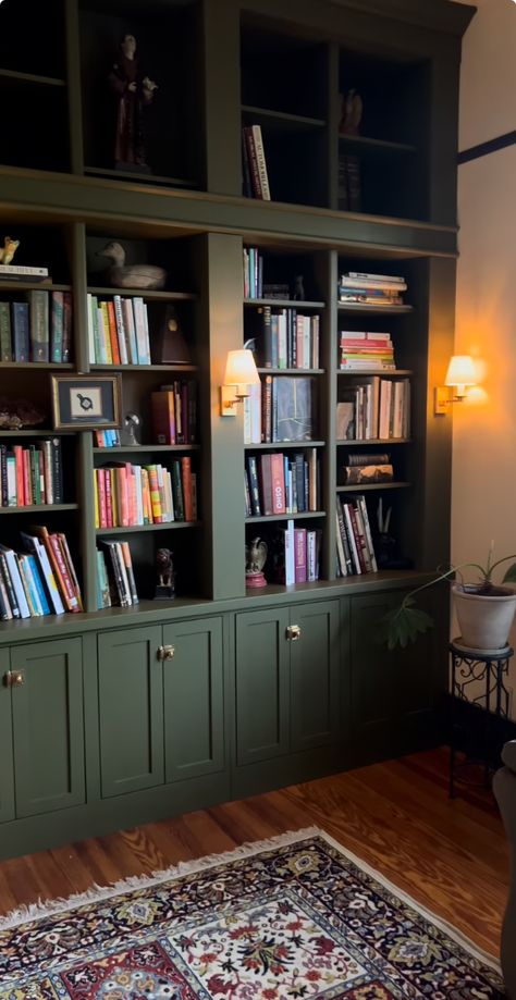 Green Arch Book Shelf, Forest Green Bookcase, Green Bookshelves Built Ins, Green Wall Library, Green Painted Built Ins, Green Living Room Built Ins, Dark Bookcase With Wallpaper Backing, Forest Green Bookshelf, Dark Green Snug Room