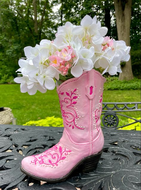 A pink cowboy boot vase with flowers in it Cowgirl Boot Vase, Cowboy Boot Flowers, Boot Flower Vase, Cowboy Boot Flower Vase, Boot Vase, Boots Flowers, Pink Cowboy Boot, Cowboy Boot Vase With Flowers, Cowboy Boot Ceramic