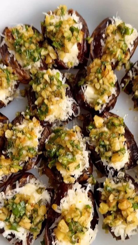 5.9K views · 116 reactions | FETA-PARMESAN ROASTED STUFFED DATES WITH HONEY-WALNUT HERB CRUNCH! •Cre by @starinfinitefood For the topping: 1/3 cup walnuts, finely chopped 1 tbsp finely chopped rosemary 2 tbsp chopped scallions 2 tbsp chopped parsley or arugula 1/2 tbsp olive oil 1/2 tbsp honey 1 tsp orange zest 1/4 tsp salt Pepper to taste • 10 oz dates, sliced open on one side Honey 3 oz feta cheese, sliced into 1 inch “pieces” 3/4 cup shredded Parmesan cheese • 1️⃣Preheat the oven to 375. 2️⃣Make the topping by adding all ingredients to a bowl and mixing. 3️⃣Add some honey to a small bowl and add the Parmesan to a small plate. Dip the feta into honey, then the Parmesan to coat. Add the feta to the center of the dates. 4️⃣Add the dates to a casserole dish. Top with topping. Bake for 15 m Feta Parmesan Roasted Stuffed Dates, Feta Stuffed Dates, Stuffed Dates, Crunch Recipe, Honey Walnut, Recipes Appetizers, Recipes Appetizers And Snacks, Small Plate, Party Apps