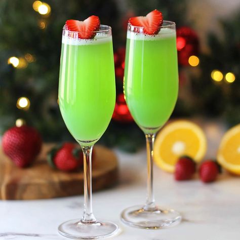 If you loved my Grinch cocktail, you'll adore this festive twist: the Grinch Mimosa! Refreshing, light, and oh-so-simple, these green mimosas are perfect for Grinch Liquor Drink, Green Grinch Mimosa, Grinch Mimosas Recipe, Grinch Theme Alcohol Drink, Festive Adult Beverages, Grinch Mimosa Mocktail, Mimosa Christmas Drink, Grinch Champagne Drink, Best Easy Cocktails