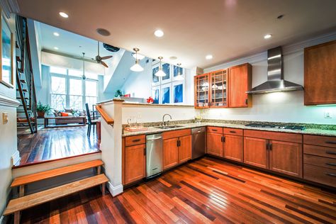 The sunken kitchen of this Washington, D.C., condo has stainless-steel appliances and granite countertops. Sunken Kitchen Ideas, Sunken Kitchen, Interior Column Design, Castle Playground, Split Kitchen, Split Level Home Designs, House Flips, Kitchen Revamp, Music House