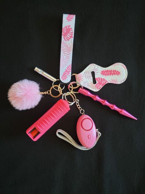 The Pink Floral Keychain Bundle comes with a wristlet, chapstick holder, Kubaton stick, safety alarm/flashlight, pepper spray, pompom, and safety emergency whistle. Kubaton Stick, Pink Flashlight, Emergency Whistle, Keychain Bundle, Safety Keychain, Safety Alarm, Floral Keychain, Chapstick Holder, Cute Pink