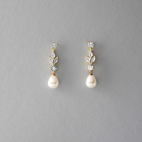 An off-white teardrop pearl hangs below glowing CZ leaf jewels in these classically made wedding earrings. These post-back pierced earrings are rhodium, gold, or rose gold plated, AAA grade CZ, synthetic pearl, measure 1.25 inches long and 3/8 of an inch wide, and are lead and nickel-free. Opal Jewelry For Wedding, Wedding Day Pearl Earrings, Summer Wedding Flower Earrings, Yellow Gold Wedding Earrings, Timeless Bridal Earrings, Pearls On Wedding Day, Bridal Earrings Boho, Gold Wedding Earrings Bride, Earrings For The Bride