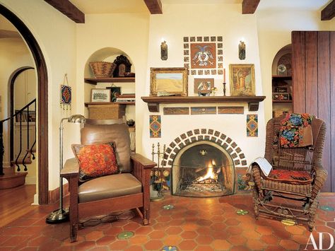 Ronstadt’s study, nestled between the entrance hall and a guest room, features original tile work around and above the fireplace. A Native American beaded bag hangs at left, near a signed William Morris chair. The paintings on the mantel are by Maynard Dixon. Southwest Fireplace, Mexican Tile Fireplace, Mediterranean Fireplace, Spanish Fireplace, Summer Kitchens, Kiva Fireplace, Fireplace Mantel Designs, Fireplace Mantel Shelf, Tile Fireplace