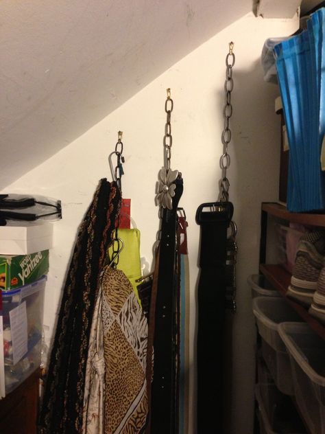 A cheap way to store light weight things such as belts, scarves and hats.  I strung lamp chain from a heavy duty picture frame hook then used large sized "s" hooks to hang my belts and scarves.  It's very functional but not very pretty but it is hidden on a wall inside my closet. Diy Belt Hanger, Scarves Organization Ideas, Sneaker Room, Attic Decor, Chain Clothing, Belt Display, Belt Hanger, Scarf Organization, Diy Belts