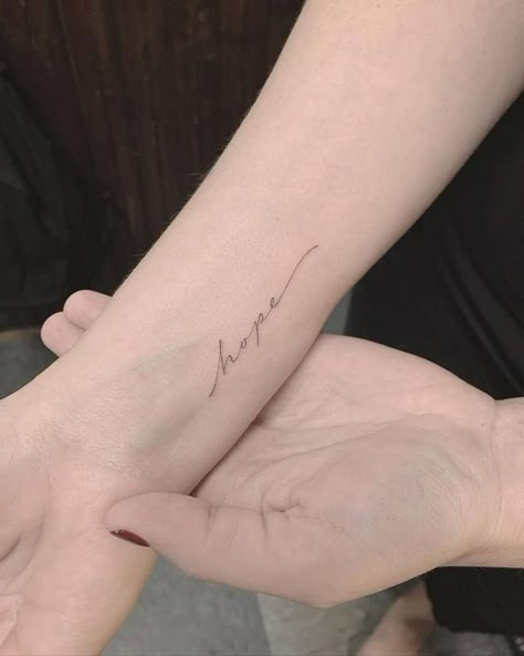 Single Needle Tattoos | Tattoofilter Hope Tattoo On Wrist, The Word Hope Tattoo, Tattoo Words On Wrist, Pretty Cursive Tattoos, Pretty Writing Tattoos, Wrist Saying Tattoos, Words Tattoo Wrist, Hope Cursive Tattoo, Peace Cursive Tattoo