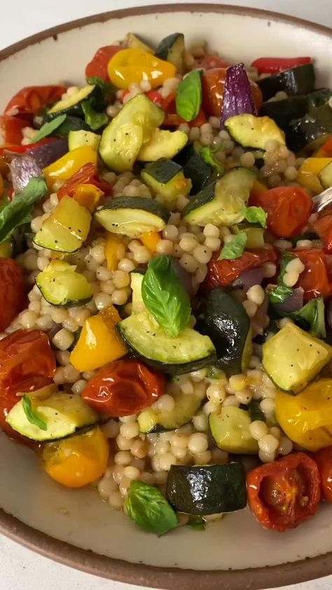 Full of vibrant colors and layers of flavors, this simple recipe for Israeli couscous salad with roasted vegetables is warm and satisfying. Vegetarian Mediterranean Diet Recipes, Vegetarian Mediterranean Diet, Vegetarian Mediterranean Recipes, Vegetable Couscous Salad, Roasted Vegetable Couscous, Mediterranean Dinner Recipes, Mediterranean Salads, Mediterranean Couscous Salad, Couscous Salad Recipes