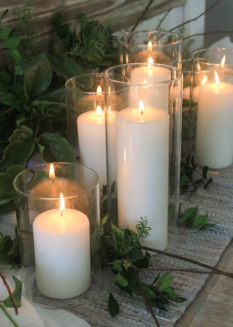 A simple combination of white pillar candles and foliage make a classic Christmas table decoration. Featured 7cm wide Event Pillar Candles in glass vases by www.candleco.com.au Tall Glass Candles, Candles In Glass Vases, Tall Candle Holders Decor Ideas, Coffee Table Candle Centerpiece, Big Candle Holder, Seasonal Branches, Wedding Table Styling, Candle Centrepiece, Pillar Candles Wedding