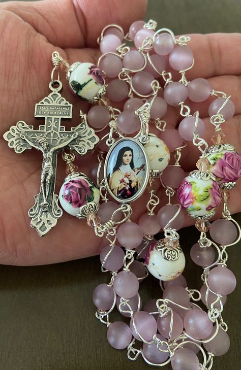 "This beautiful handmade rosary is made with 8mm cat's eye matte pink glass, 10mm ceramic beads and 2\" Pardon crucifix.   Length: 20\" inches long" Rosary Aesthetic, Rosary Art, Beautiful Rosary, Handmade Rosary, Catholic Decor, Glow Jewelry, Inspire Bible Journaling, Cross Art, St Therese