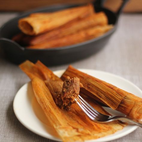 New Orleans-Style Hot Tamales | Emerils.com -- A spicy, chile-laden filling is rolled in corn husks and then steamed in a flavorful broth. These tamales do take some time, but invite friends over and make it a communal effort or do it in stages, time permitting. The filling can be made one day, then refrigerated for up to several days before rolling and steaming the tamales. Once cooked, the tamales hold well in the refrigerator up to several days, can also be frozen and microwaved to reheat. Hot Tamales Recipe Southern, Relleno Recipes, Hot Tamales Recipe, Cajun Meals, Homemade Tamales Recipe, Soul Recipes, Louisiana Cooking, Latin Dishes, Mexican Tamales