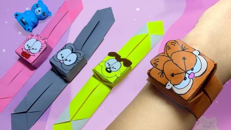 Charming origami paper wristbands adorned with beloved characters like Garfield and Friends, thoughtfully folded and crafted for playful style. Join the tutorial to learn step-by-step instructions, turning paper into delightful accessories that capture the essence of creativity and fun. 🐱🎨 #DIYAccessories #CharacterCrafting Garfield Papercraft, Diy Garfield Crafts, Garfield Graduation, Garfield Craft, Garfield And Friends, Origami Dresses, Garfield Strip, Garfield Collectibles, Origami Dress