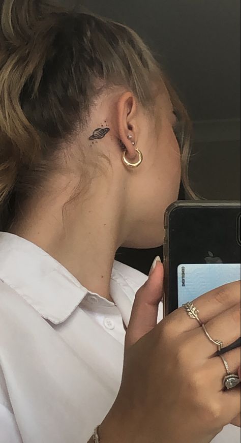 Planet Tattoos Behind Ear, Planet Behind Ear Tattoo, Saturn Tattoo Behind Ear, Moon And Saturn Fine Line Tattoo, Saturn Stick And Poke, Small Snake Tattoo Placement, Saturn Tiny Tattoo, Behind The Ear Tattoo Ideas, Lil Tattoos