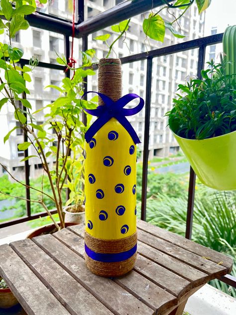 Here is a simple bottle art design I tried recently All you need is 1. Bottle of your choice 2. Acrylic colors White, Yellow n Violate 3. Jute Rope 4. Violate ribbon 5. Paint brushes 6. Mandala pens to have the polka dots 😃😃😃. #bottledecor #bottlediy #creativity #artwork #diy #balconydecorideas Mandala Pens, Bottle Art Design, Creativity Artwork, Simple Bottle Art, Artwork Diy, Jute Rope, Bottle Art, Acrylic Colors, Paint Brushes