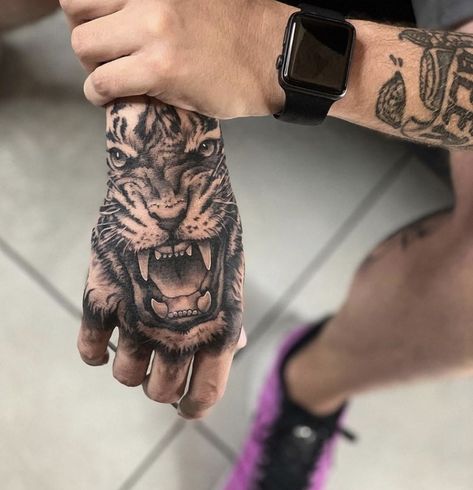 Tiger On Hand Tattoo, Tiger Hand Tattoo Men, Hand Tattoos Tiger, Tatoos Men Hand Ideas, Animal Hand Tattoo, Handtattoo Ideas, Men’s Hand Tattoos, Lion Hand Tattoo Men, Best Hand Tattoos Men