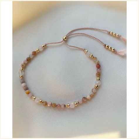 [PaidLink] Delicate Peruvian Pink Opal And Moonstone Gemstone Bracelet Made With A Blush Pink Thread And 14Kt Gold Filled Beads. The Bracelet Has A Slider Bead, Which Makes It Easy To Adjust The Tightness To Your Liking. Individually Selected High Quality Gemstones Make The Bracelet Truly Special And One Of A Kind. The Delicate And Minimalist Design Goes Well With Both Casual And Sophisticated Looks. You Can Layer The Bracelet Or Wear It By Itself. Total #diydaintybracelet Pink Opal Bracelet, Self Made Bracelets, Gemstone Bracelets Ideas, Wearing Bracelets, Woman Bracelets, Bracelets Stone, Bracelet Stones, Bracelet Cord, Opal Moonstone