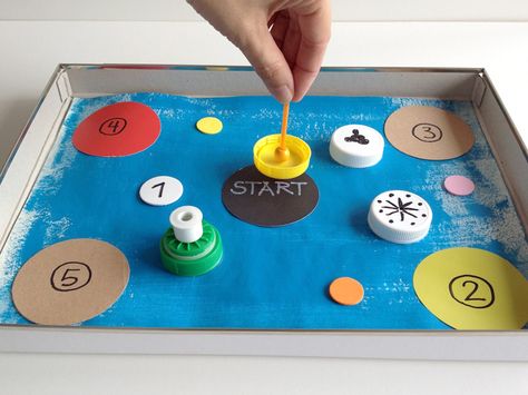 DIY Spinning Top Game Boards | Handmade Charlotte Diy Spinning Wheel Game, Diy Spinning Top, Button Spinner Toy, Diy Spinning Mechanism, Wooden Tops Spinning, School Age Activities, Halloween Express, Handmade Charlotte, Recycled Bottle