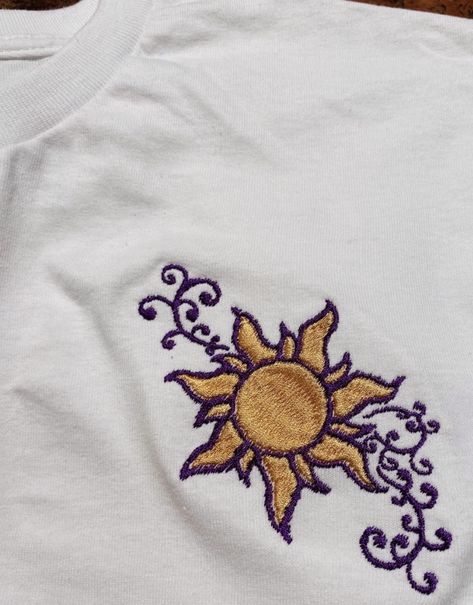 https://www.etsy.com/sg-en/listing/1017509464/ Rapunzel Embroidery Design, Tangled Sun Embroidery, Tangled Embroidery, Rapunzel Embroidery, Embroided Pants, Disney Embroidery Designs, Tangled Flower, Disney Canvas Art, Embroidery Hoop Art Diy