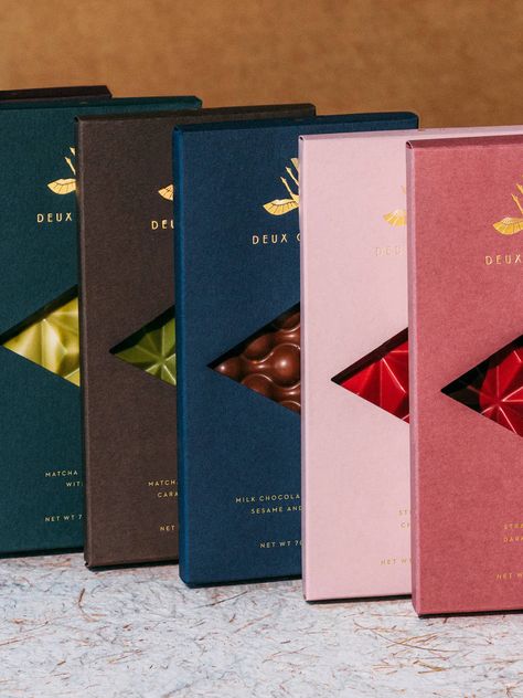 All nine chocolate bars of our beautiful permanent collection, inspired by Japanese flavors. Perfect for any gifting occasion!Passionfruit ChocolateCreme Brulée ChocolateMatcha Chocolate with Caramelized SesameDark Chocolate and Caramelized Salted HazelnutStrawberry and Dark ChocolateMilk Chocolate with Ginger, Sesame, Chocolate Animation, Cacao Packaging, Chocolate Moodboard, Chocolate Bar Packaging Design, Chocolate Store Design, Bar Packaging Design, Matcha Almond, Chocolate Bar Packaging, Chocolate Package