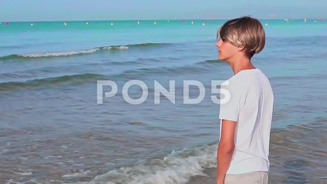 Handsome Teenager Stands On The Seashore And Looks Into The Distance Motion Backgrounds, Motion