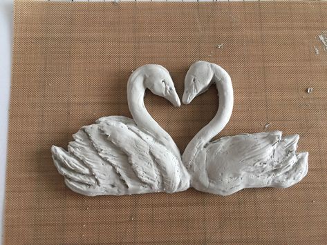 trimmed off some excess around the edges of necks, but now need to do a ton of refining.  I have noticeable creases on the lower body and head of the female swan (one on the right), where I had placed clay into the mold. Air Dry Clay Swan, Clay Swan, Paper Mache Swan, Swans Making A Heart, Animal Pinch Pots Swan, Swan Drawing, Swan Ice Sculpture, Cute Clay, Clay Art Projects