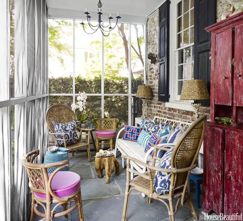 The screened porch is a favorite spot for casual get-togethers and a convenient space to accommodate overflow at the many parties Gregg hosts. Vintage wicker and rattan furniture, enlivened by a mix of colorful pillows, evokes a breezy tropical air. Candlesticks were turned into lamps and topped with shades.   - HouseBeautiful.com Charleston Homes, Old Cottage, The Porch, Screened Porch, Wicker Furniture, Indoor Outdoor Living, Eclectic Style, Shop Chair, Eclectic Decor