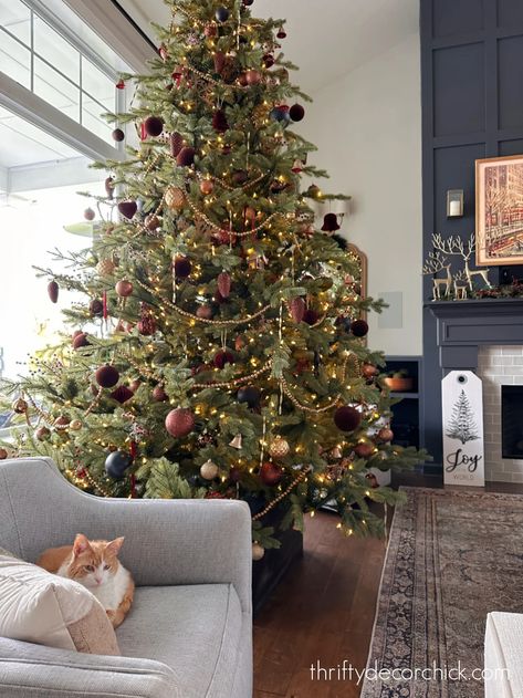 Moody Boho Christmas, Christmas Tree Dark Academia, Chris Loves Julia Christmas Tree, Droopy Christmas Tree, Muted Color Christmas Tree, Christmas Tree Tall Ceilings, Cozy Christmas Tree Decor, Christmas Tree Ideas Red White Gold, Burgundy And Bronze Christmas Tree