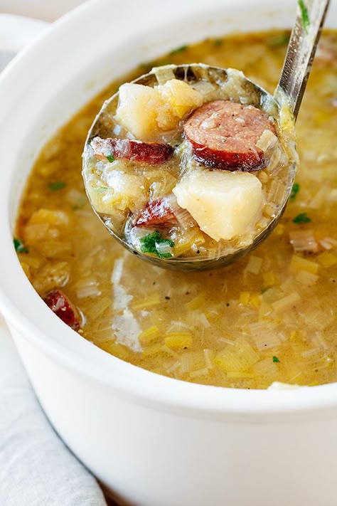 This savory potato leek soup is rich, brothy and light, filled with leeks, garlic, potatoes and hearty slices of delicious smoked sausage! | thecozyapron.com #potatoleeksoup #potatoleeksouprecipe #potatoleeksouphealthy #potatoleeksoupsausage Sausage Potato Leek Soup, Sausage Leek Soup, Recipes Using Leeks, Soup With Smoked Sausage, Soup With Leeks, Potatoes And Leeks, Soup Potato, Leek Potato, Leeks Soup Recipes