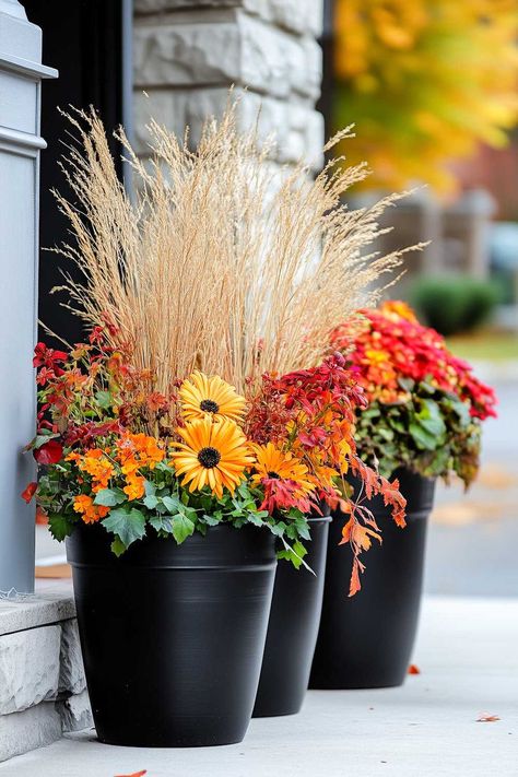 Easy outdoor fall planters with vibrant yellow and orange flowers. Fall Box Planter Ideas, Mums And Lanterns Front Porch, Mums In Tall Planters, Faux Mums Diy, Mums Fall Decor, Mum Porch Decor, Tall Fall Planters Front Porches, Faux Plants For Front Porch Fall, Fall Porch Decor Simple