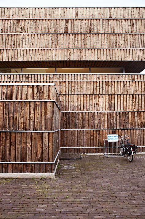 The facade is clad with 600 recycled cable reels. According to Jongert, "It took about seven minutes to dismantle each one, yielding quite a lot of wood each time." The wood was heat-treated at high temperatures, a natural weatherproofing technique. Cable Reels, Wooden Cladding, Recycled House, Wood Facade, Wooden Facade, Facade Material, Cladding Materials, Wood Architecture, Wood Cladding