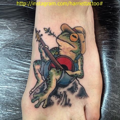 Frog playing banjo tattoo by me Frog Playing Banjo On Mushroom, Frog With Banjo Tattoo, Animal Playing Banjo Tattoo, Traditional Banjo Tattoo, Frog Tattoos Traditional, Frog With Guitar Tattoo, Sitting Frog Tattoo, Frog Guitar Tattoo, Frog Playing Guitar Tattoo