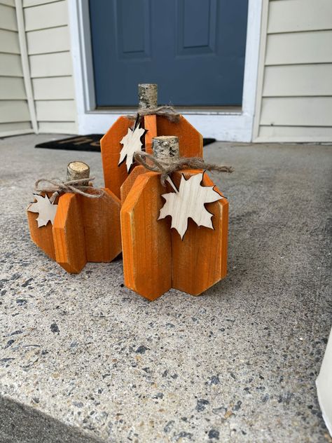 This set of 3 wooden pumpkins with leafs make a great accent piece to any home. The pumpkins are made out of cedar. I then put the orange paint on and sand them down to help add to the rustic look.  Finally I add the stem and tie the bow with the leaf.  The tall pumpkin stands about 8 inches tall including the stem.  The medium one stands about 6 inches tall including the stem.  The shortest one stands about 5 inches tall including the stem.  They are each roughly 5-1/2 inches wide. They are for inside or outside of ... Rustic Wood Pumpkins Diy, Stump Pumpkins Diy, Wooden Fall Crafts Diy, Pallet Fall Projects, Wooden Pumpkins Diy Front Porches, Diy Wood Fall Decorations, Pumpkin Wood Crafts, Wooden Fall Crafts, Halloween Wood Projects