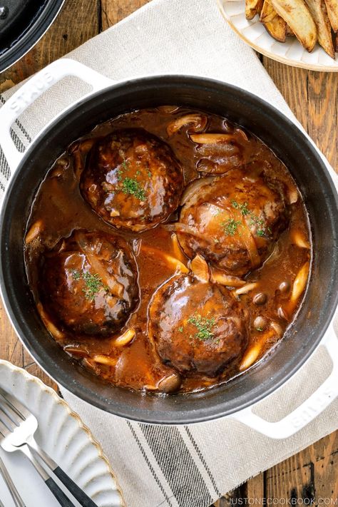 Japanese Stewed Hamburger Steak called Nikomi Hambagu is made with seared beef and pork patties cooked in a delicious wine-reduction gravy sauce along with mushrooms and onions, with an optional melted cheese on top. This Western-style Japanese hamburger steak is juicy, tender, and full of bold complex flavors. #hambagu #hamburgersteak | Easy Japanese Recipes at JustOneCookbook.com Easy Beef Tips, Japanese Hamburger Steak, Japanese Cookbook, Japanese Hamburger, Beef Tips Recipe, Pork Patties, Brazilian Steak, Hamburger Steak Recipes, Hamburger Potato Casserole