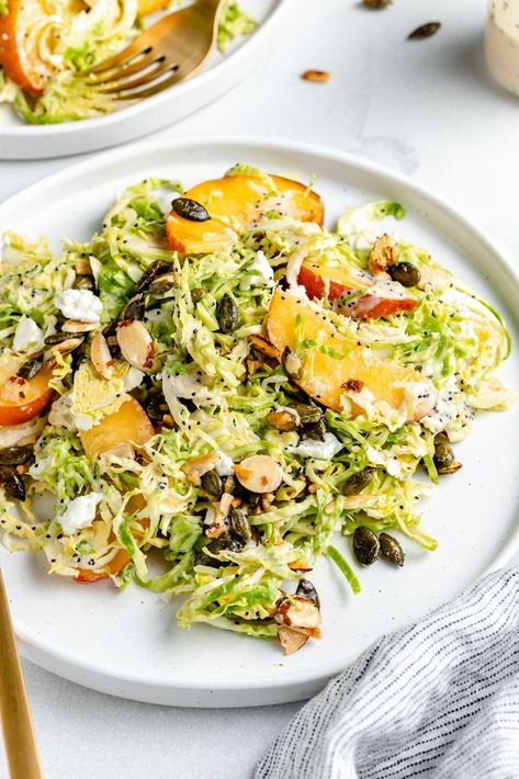 Gorgeous peach brussels sprouts salad with sweet & salty nuts and a creamy tahini poppy seed dressing. This vegetarian brussels sprouts peach salad is filled with a wonderful mix of textures and flavors. Enjoy it for the perfect summer lunch or side dish on its own or with your favorite protein! #peaches #brusselssprouts #salad #vegetarian #healthylunch Brussels Sprout Salad, Lemon Garlic Salmon, Brussels Sprouts Salad, Crunch Salad, Salad Summer, Vegan Ricotta, Sprout Salad, Poppy Seed Dressing, Ambitious Kitchen