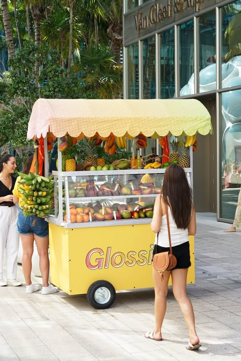 Glossier Mango Cart Miami Design District Food Cart Interior Design, Food Pop Up, Cute Food Cart, Fruit Vendor Cart, Tropical Food Truck Design, Smoothie Cart, Glossier Event, Juice Cart, Popsicle Cart