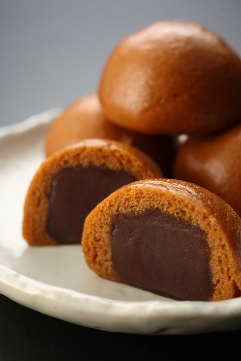 Manjū (饅頭 まんじゅう?) is a traditional Japanese confection popular in Hawaii. There are many varieties of manjū, but most have an outside made from flour, rice powder and buckwheat and a filling of an (red bean paste), made from boiled azuki beans and sugar. They are boiled together again and kneaded. There are several varieties of bean paste used including koshian, tsubuan, and tsubushian. Azuki Beans, Azuki Bean, Rice Powder, Red Bean Paste, Japanese Dessert, Red Bean, Japanese Sweets, Bean Paste, Together Again