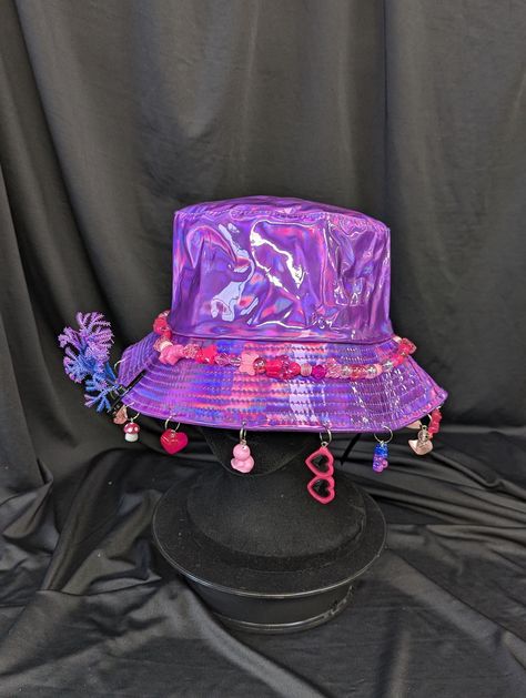 -hat color - purple -bead color - pink -charm color - pink -unisex adult size -inner circumference - 22.5in -crown dip - 3in -brim - 2.25in -NOT machine washable -Perfect for raves and outdoor festivals! Shipping within the US USPS First Class Package 3-9 days USPS Priority Mail 1-5 days USPS Priority Mail Express 1-3 days Shipping International  USPS First Class Mail International  -Varies- USPS Priority Mail International 6-14 days USPS Priority Mail Express International 3-9 days Shipping times are estimated, NOT GUARENTEED.  +International buyers are responsible for all import fees+ +Orders of $50+ may require signature confirmation upon delivery+ Bucket Hat Concert Outfit, Pink And Purple Rave Outfit, Rave Bucket Hat, Cloak Ideas, Rave Decor, Purple Rave Outfit, Ugly Fashion, Rave Hats, Rave Fit